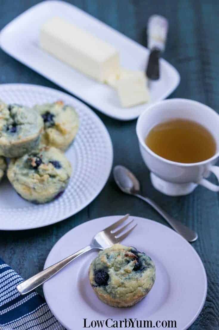 gluten free keto blueberry muffins are served on white plates with tea