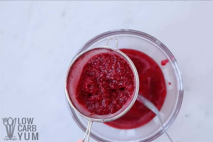 straining raspberries