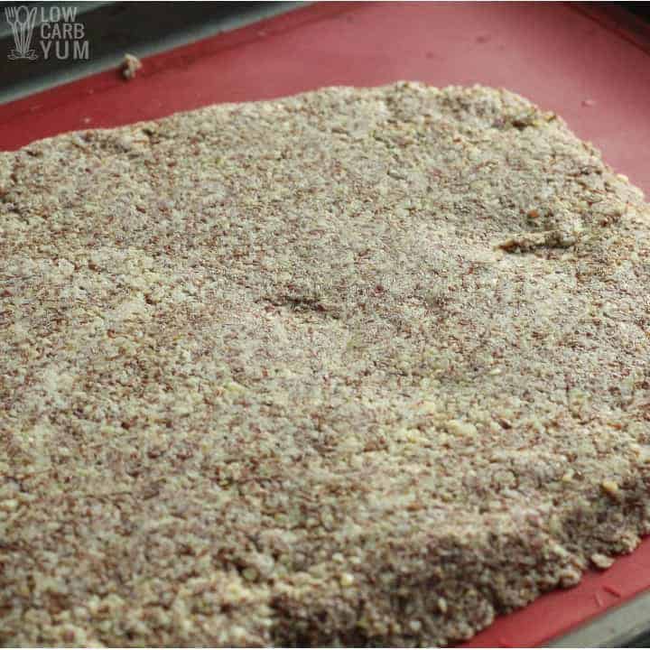 Spreading out the keto flax seed crackers dough on pan