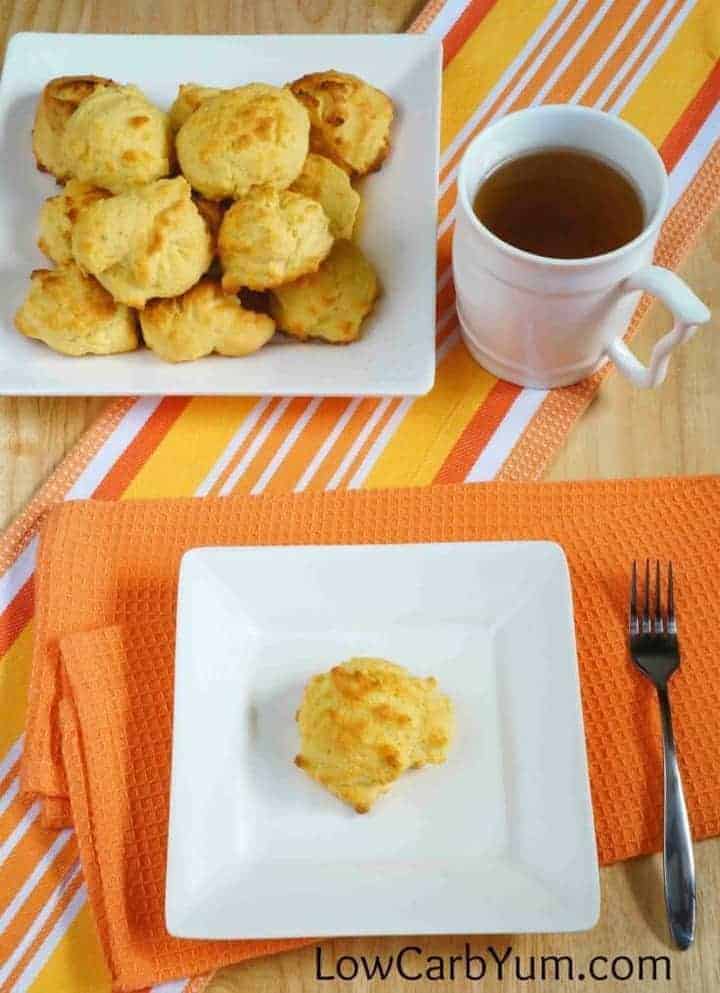 low carb cheddar biscuit on a plate next to cup of coffee