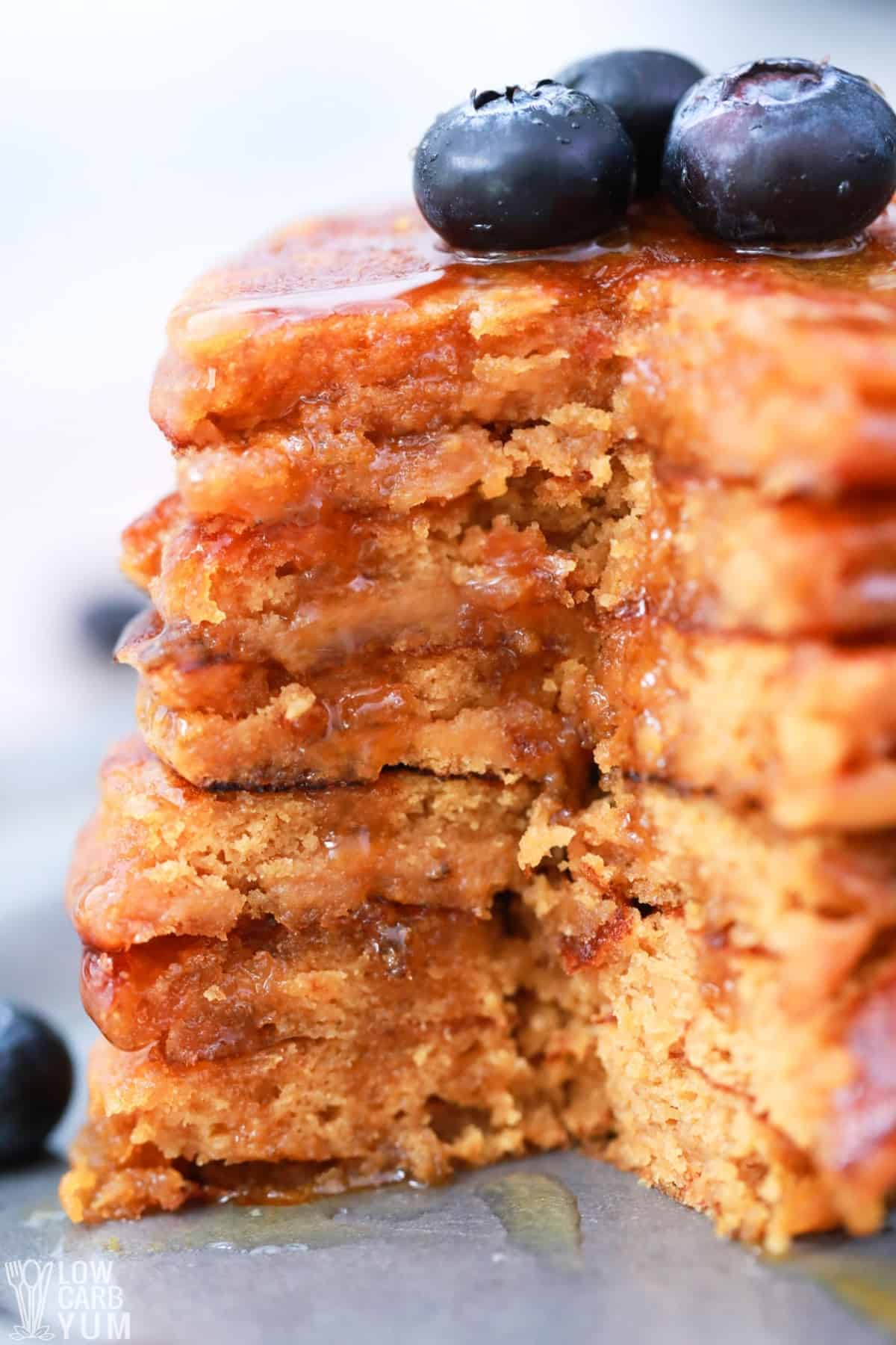 stack of pancakes cut with blueberries on top