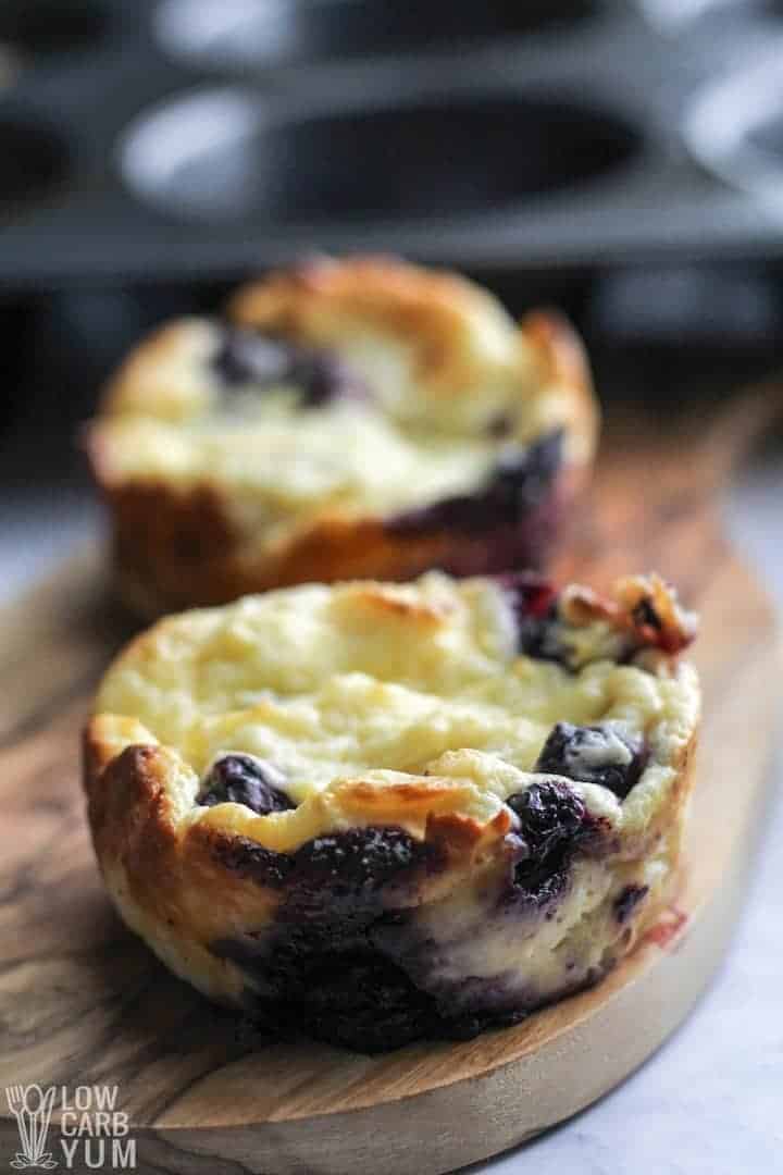 close up of berry cream cheese muffin on a serving board