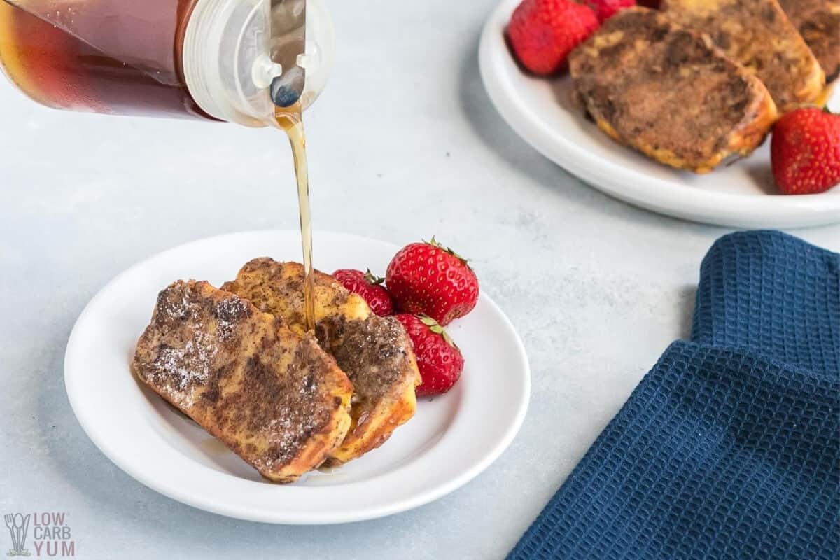 pouring maple flavored syrup on keto french toast slices