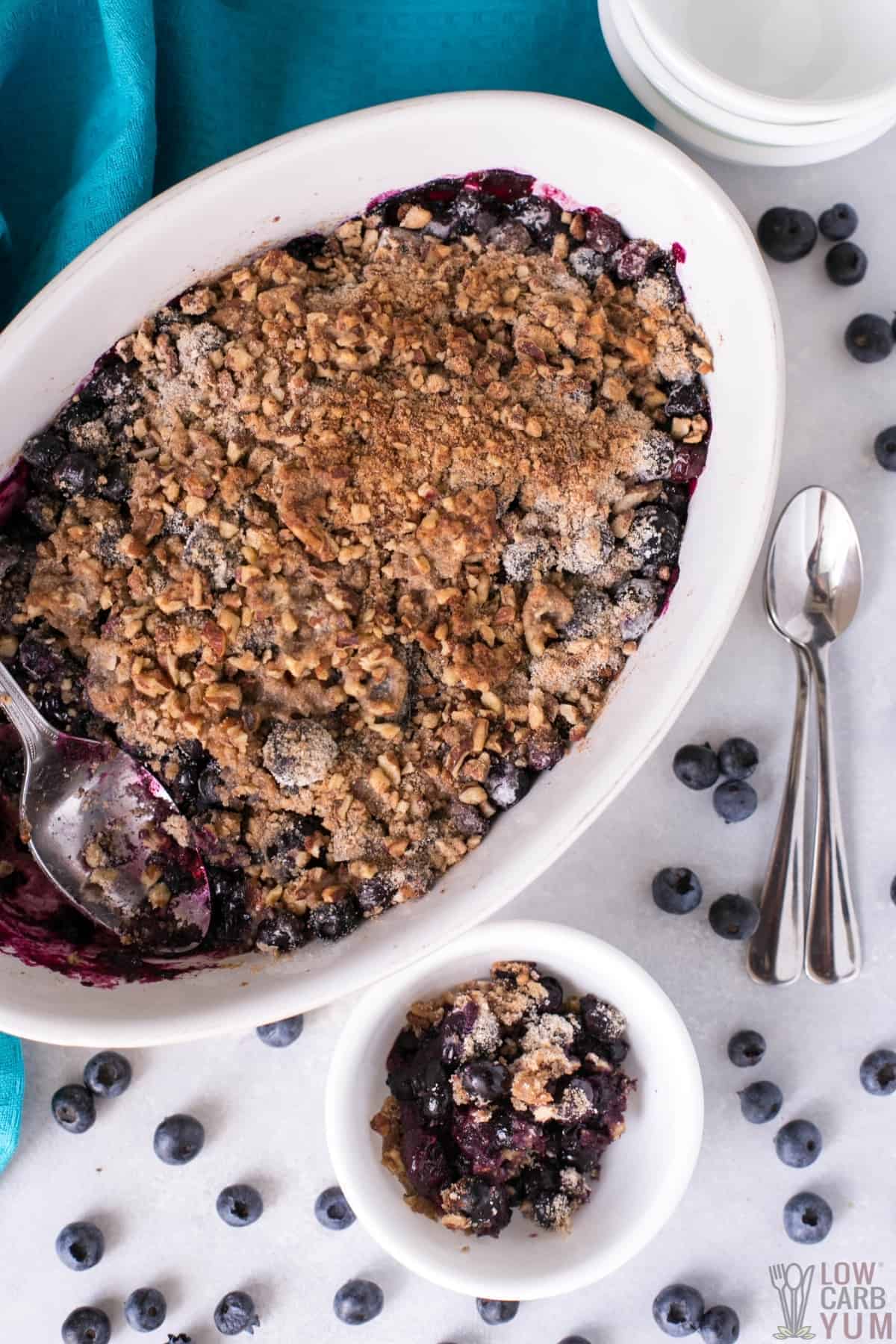 serving the gluten free blueberry crisp in small bowl