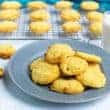 coconut flour cookies on plate with more on cooling rack