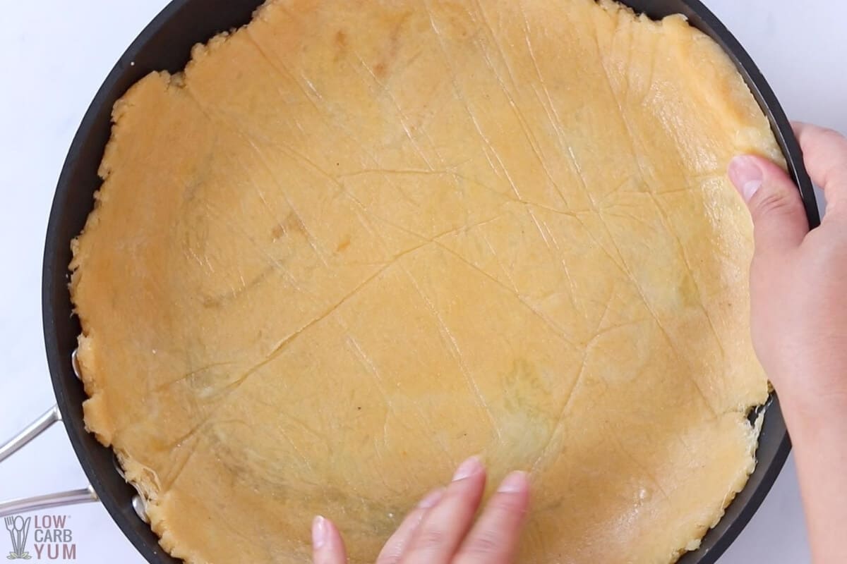 pressing fathead pizza dough in pan