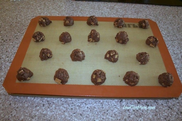 flourless chocolate cookies dough balls on lined baking sheet