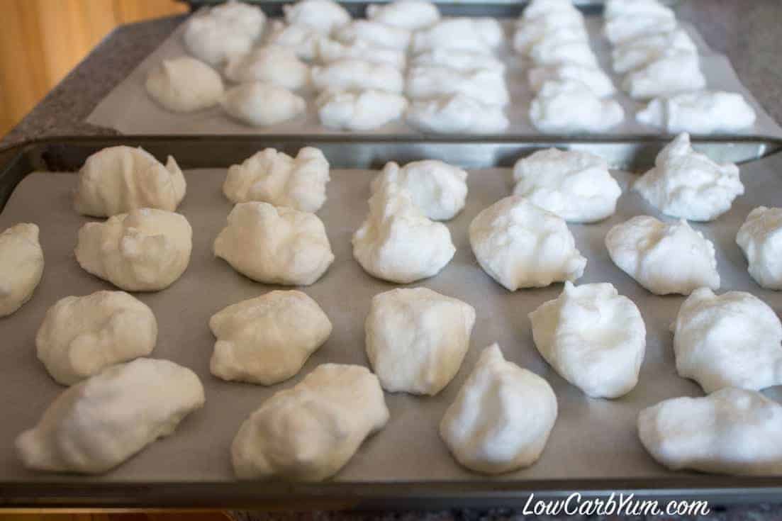 whipped egg white mixture dropped on parchment paper