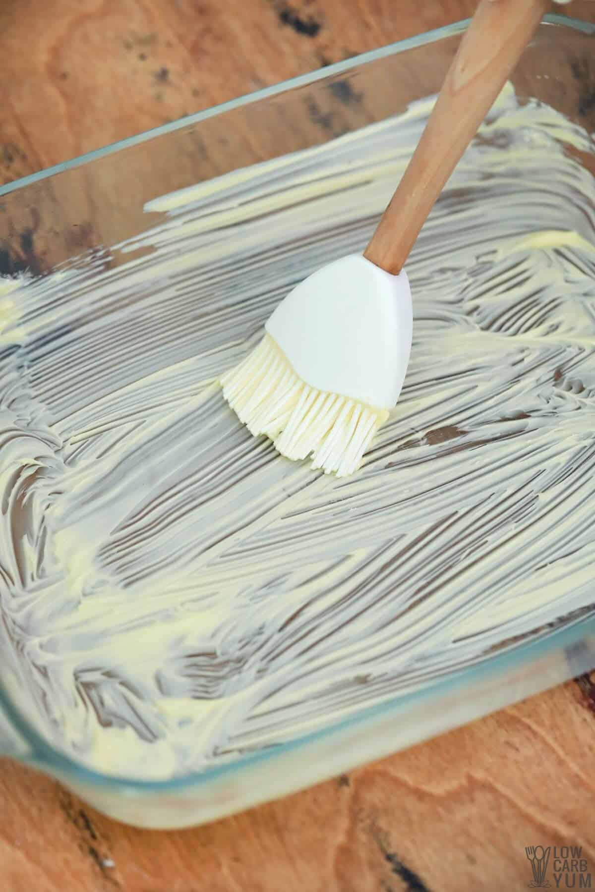 greasing pan with butter