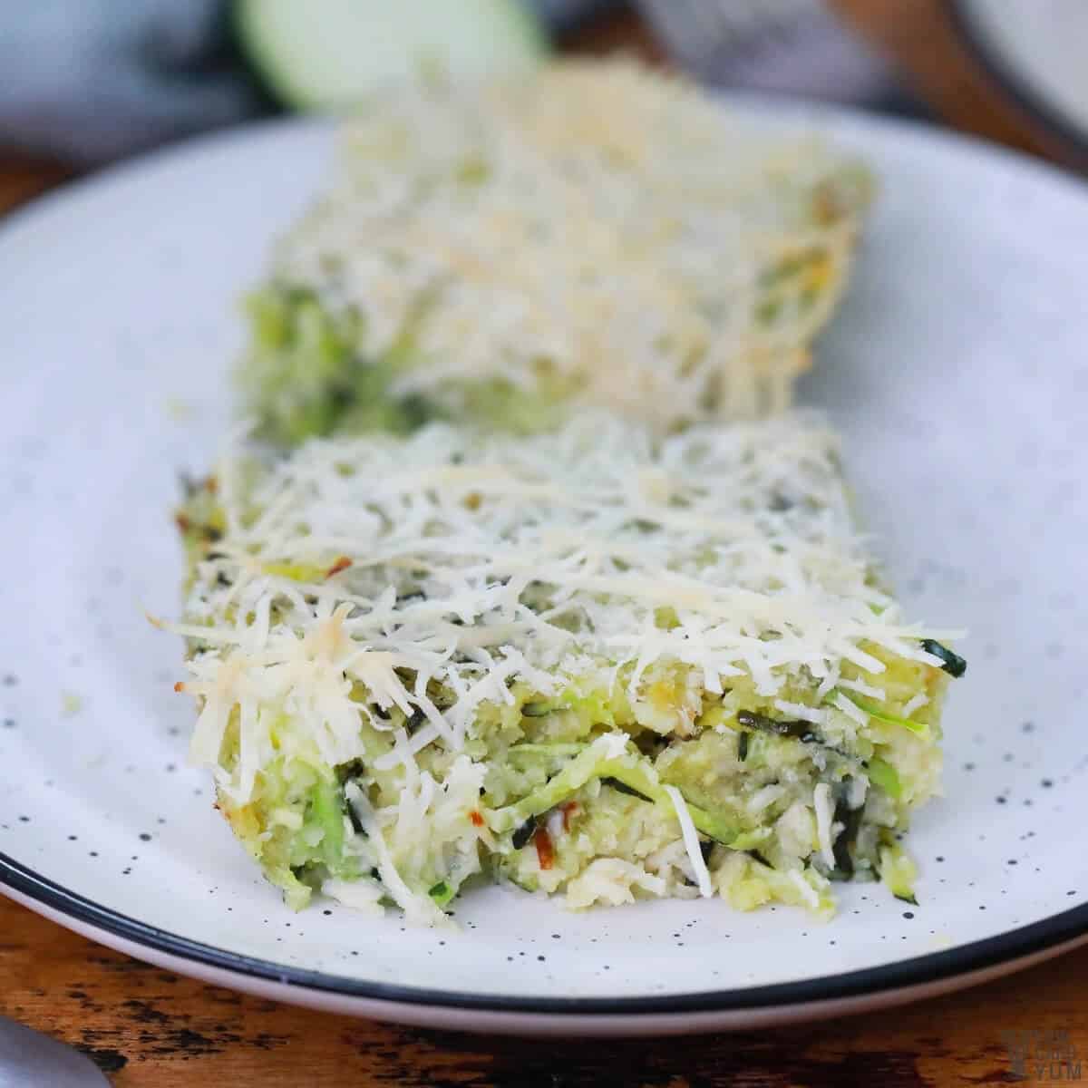 cut squares of zucchini noodle casserole on white plate