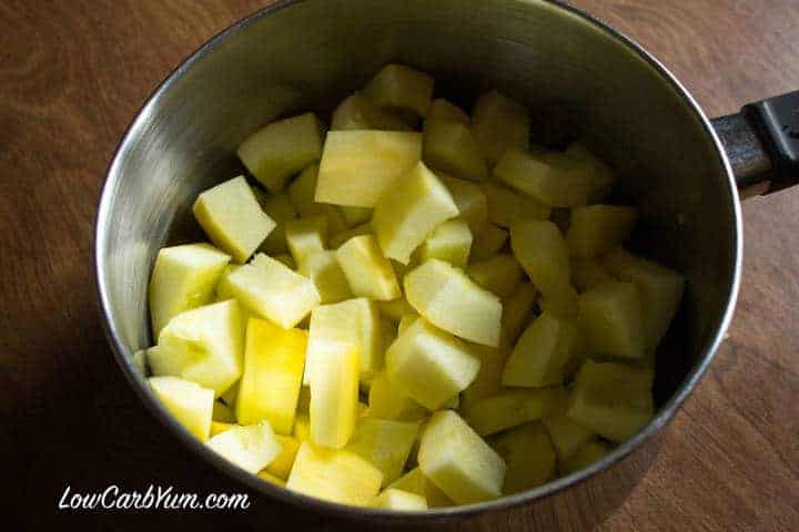 Peeled and cut yellow squash in pan