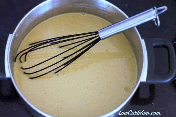 butterscotch pudding mixture in pot with whisk