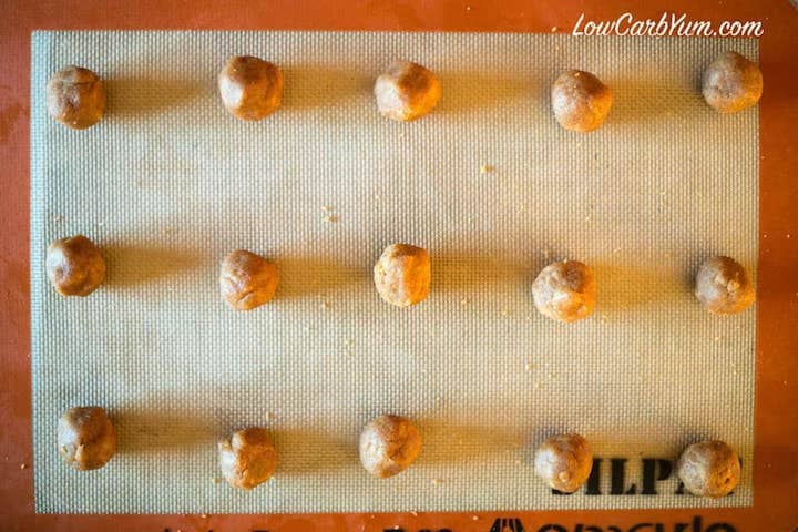 Cookie dough balls on lined baking pan