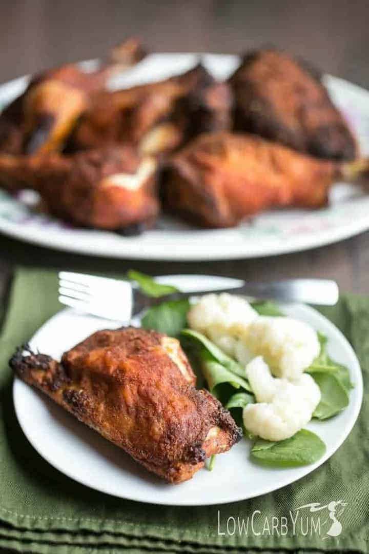crispy baked chicken legs and thighs on plate and platter