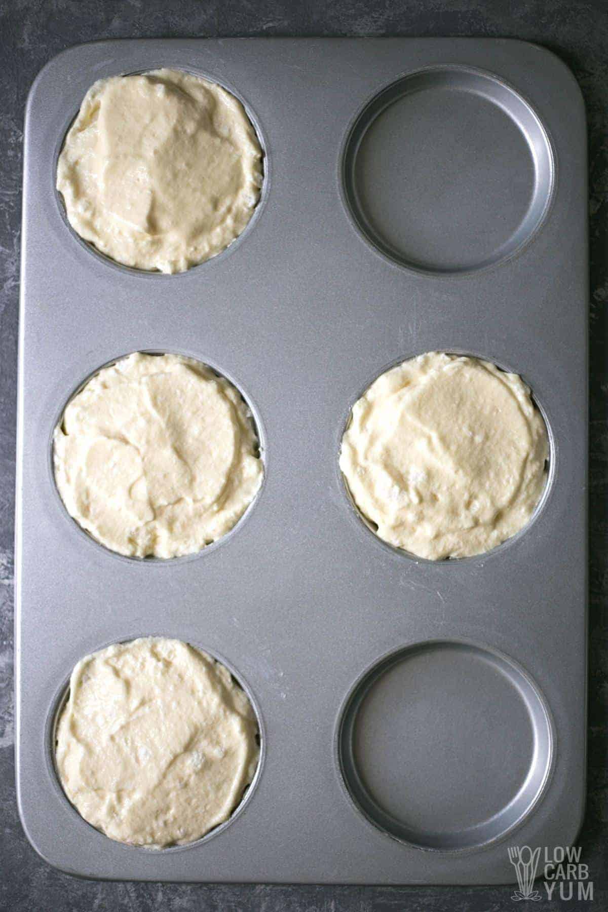 cake batter in muffin top pan molds.