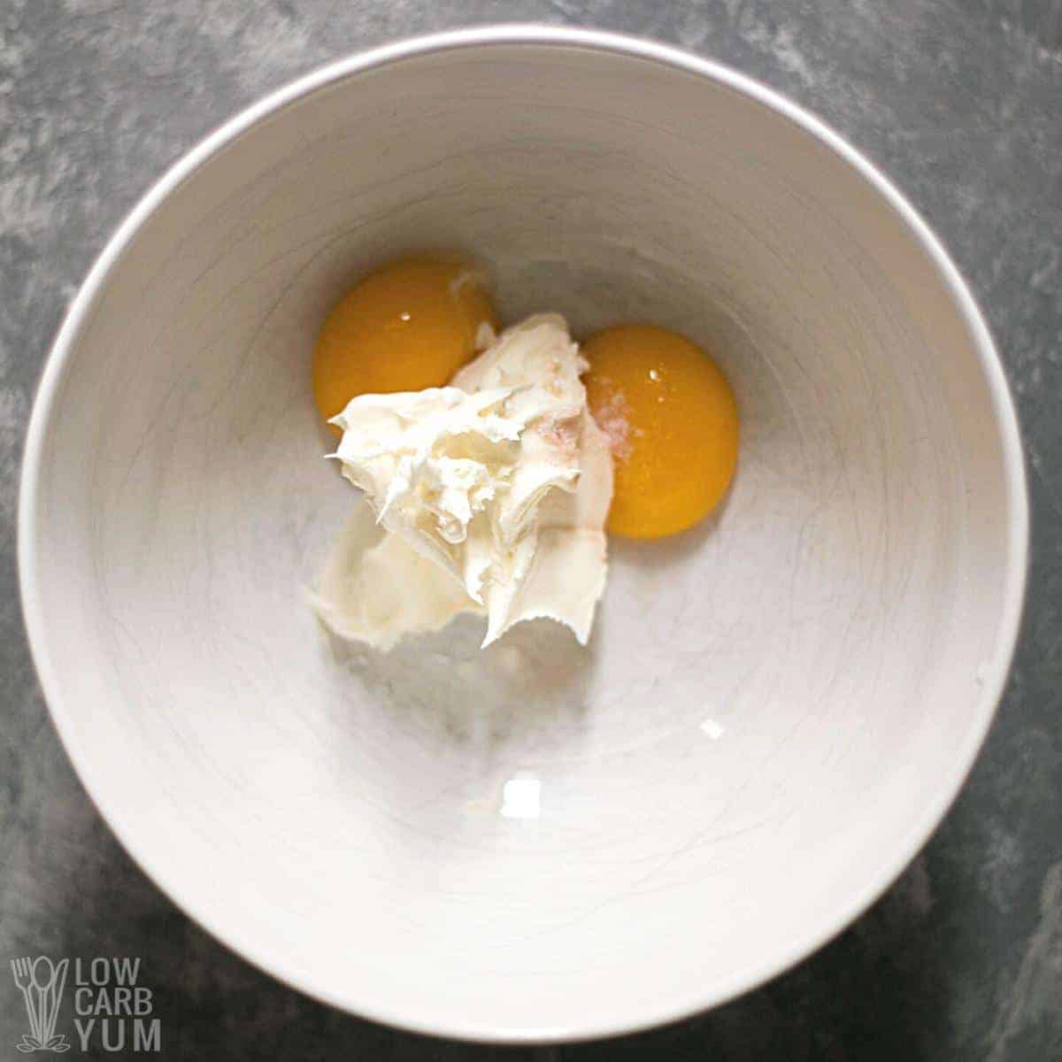 egg yolks with mascarpone cheese in white bowl.