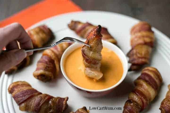 dipping bacon wrapped chicken tender in dip