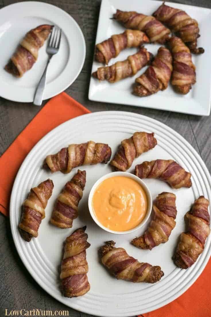 serving oven baked bacon wrapped chicken tenders on plates