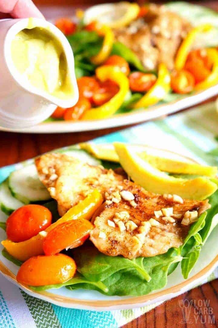 Tilapia salad with spinach and creamy avocado dressing