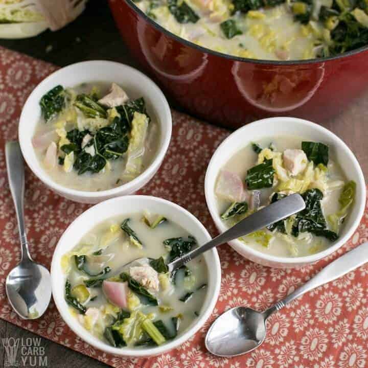 cream of turkey soup with cabbage and kale in 3 bowls and 3 spoons