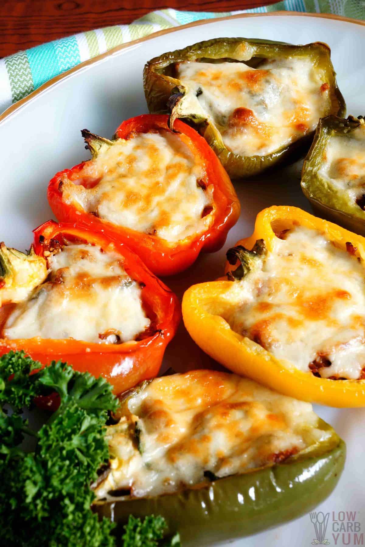 stuffed peppers on oval white platter.