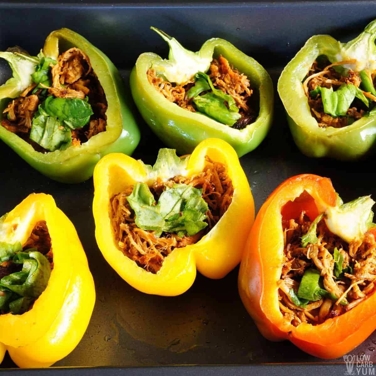 stuffing peppers with pork and spinach.