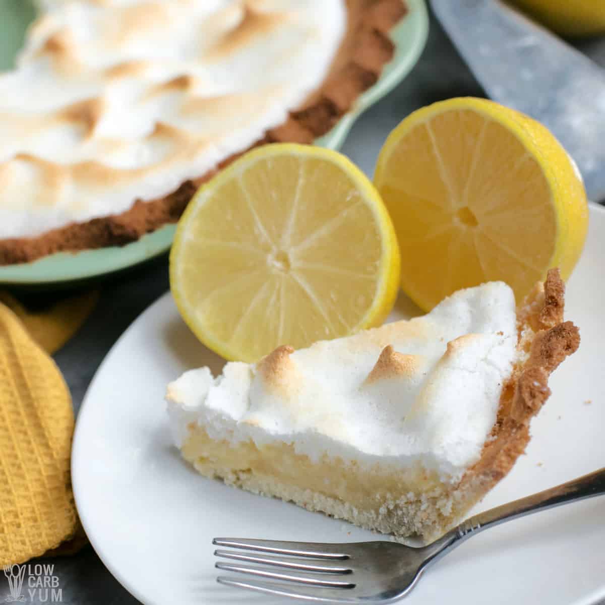 slice of keto lemon meringue pie on white plate.