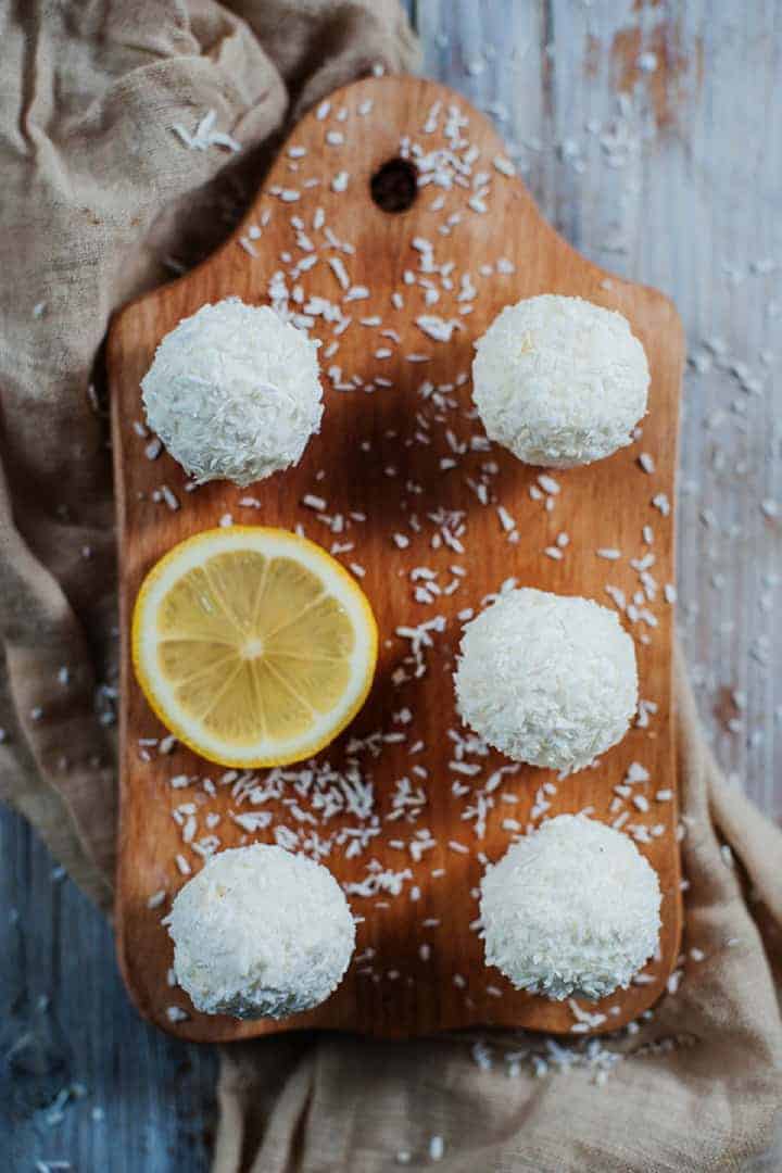 Low carb lemon coconut cream cheese balls on cutting board