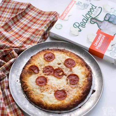 Baked frozen cauliflower pizza crust pizza by Real Good Foods. #lowcarb #keto #ketopizza #lowcarbpizza #glutenfree #grainfree #weightwatchers #Atkins #ketodiet #lowcarbdiet | LowCarbYum.com