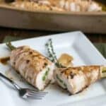 Sliced asparagus stuffed chicken on plate