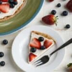 Cream Cheese Fruit Pizza on white plate with silver fork