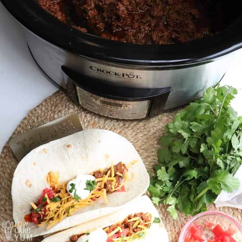 Crock Pot Tacos on plate with taco meat in crock pot