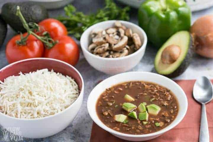 slow cooker vegan chili topped with avocado and ingredients