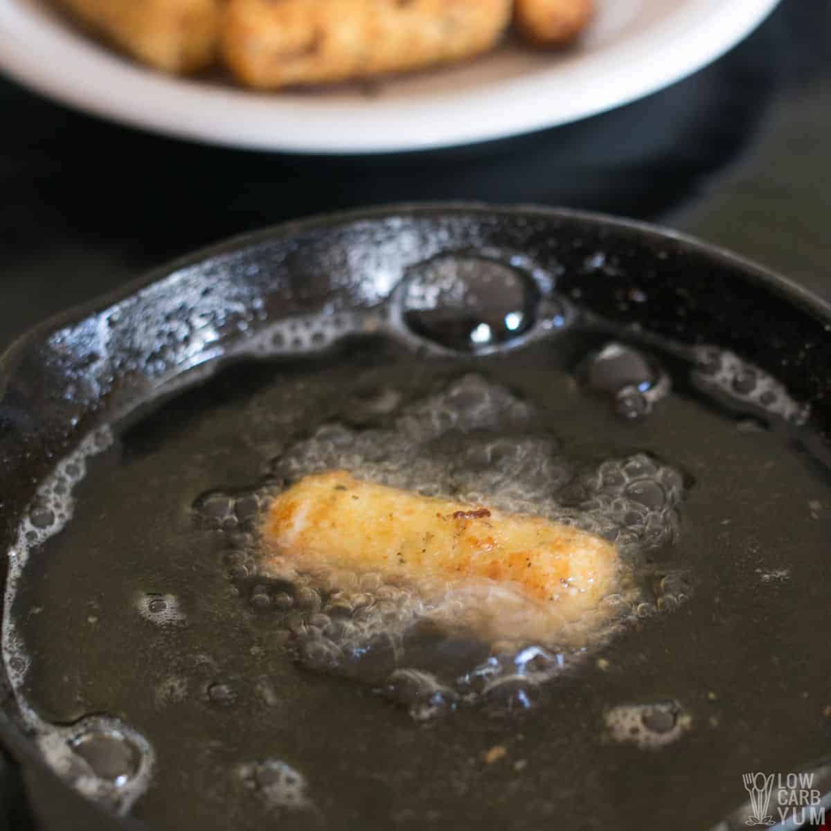 cooking a cheese stick in hot oil.