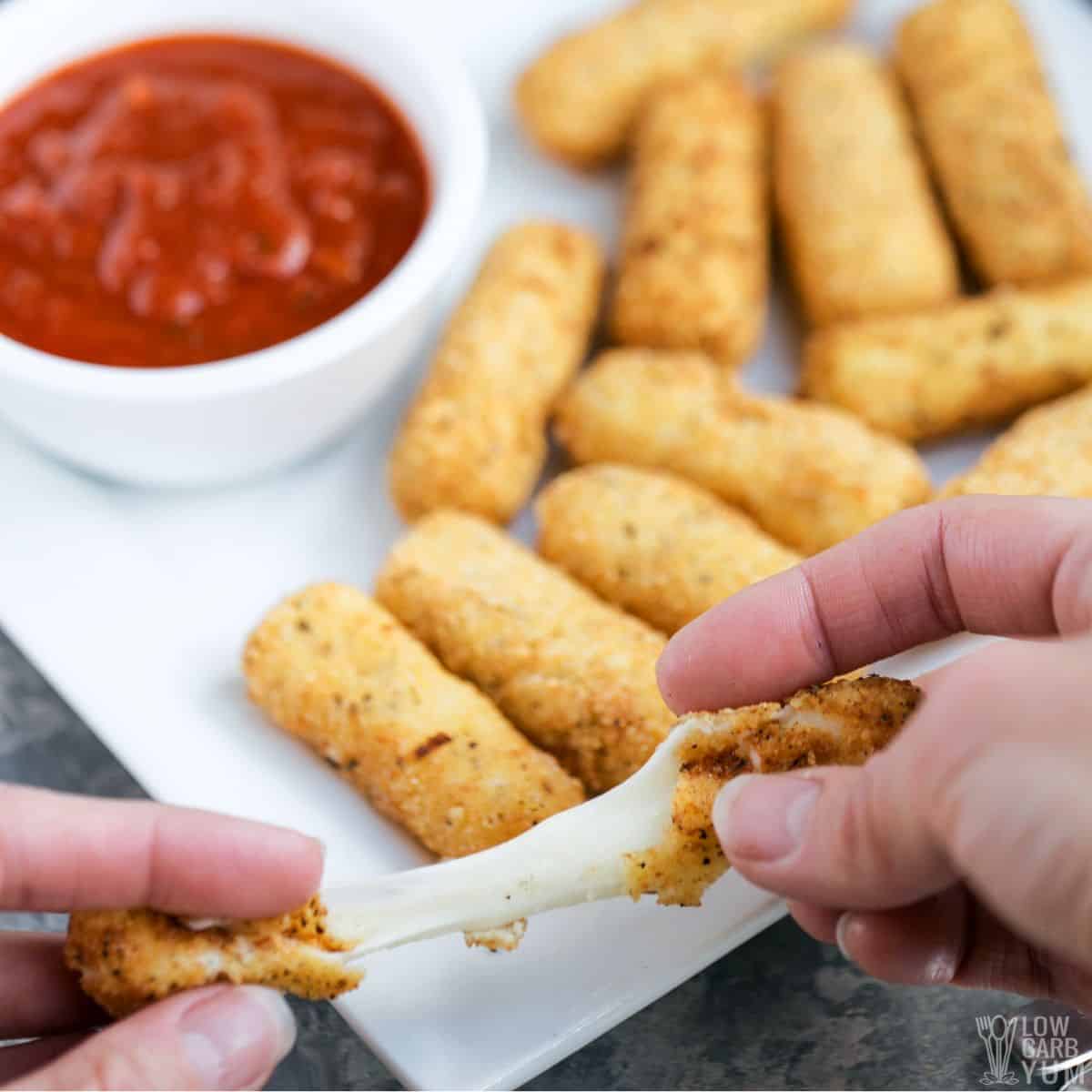 pulled apart gooey cheese stick between hands.