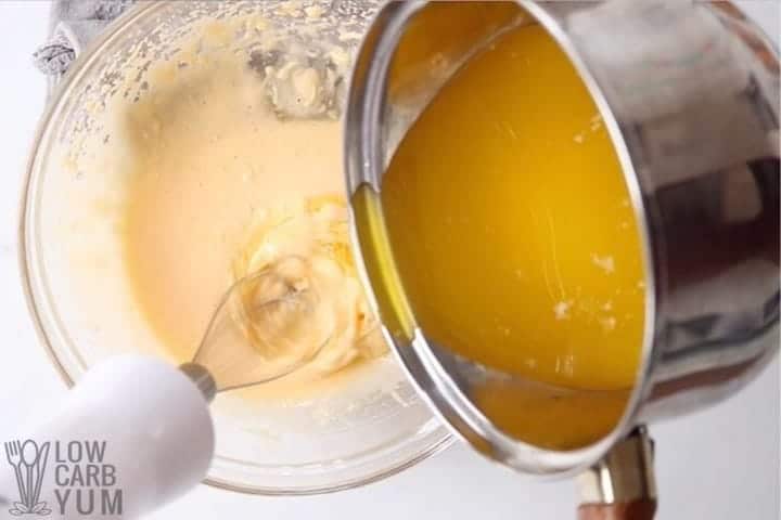 adding melted butter to yolks