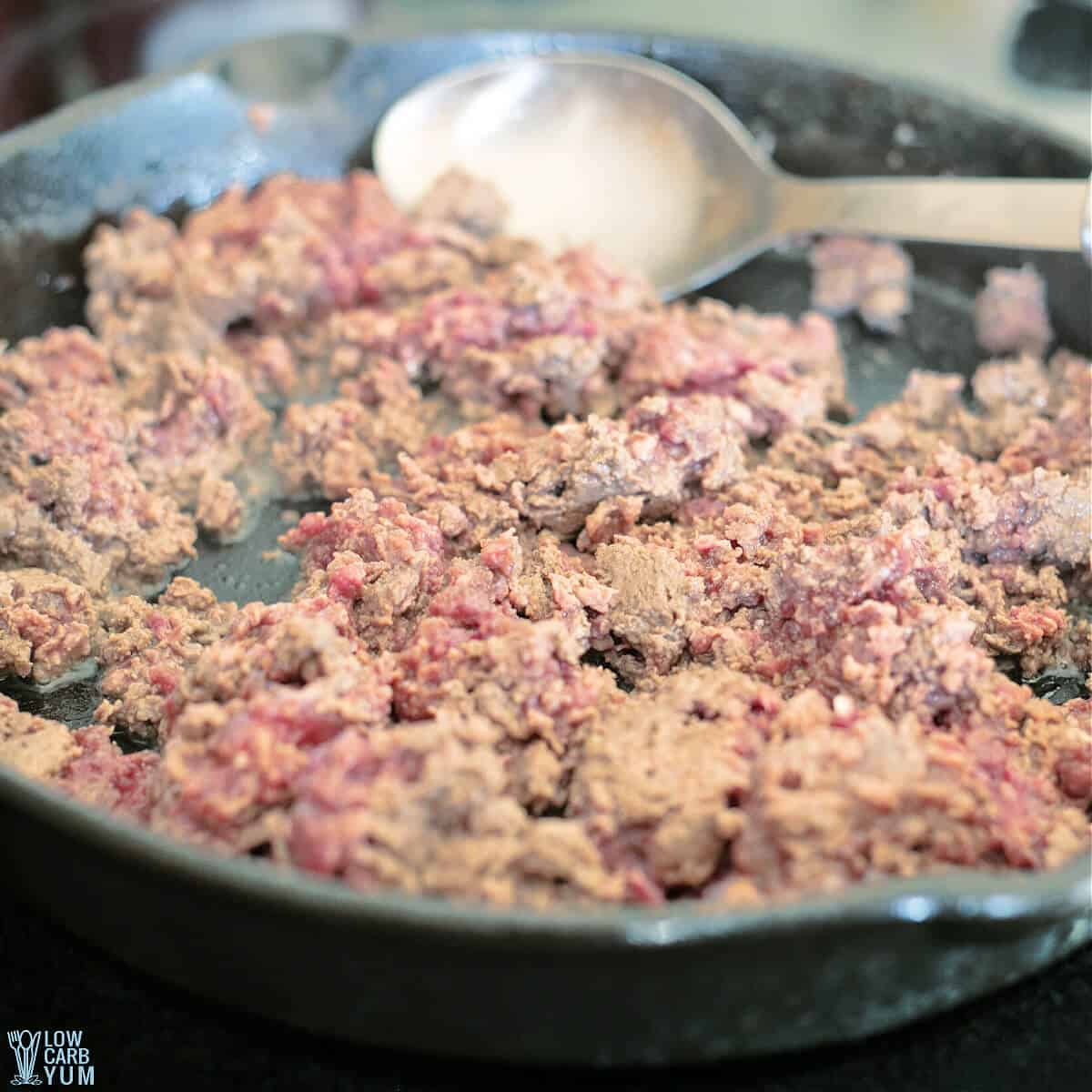 browning the ground beef in iron skillet