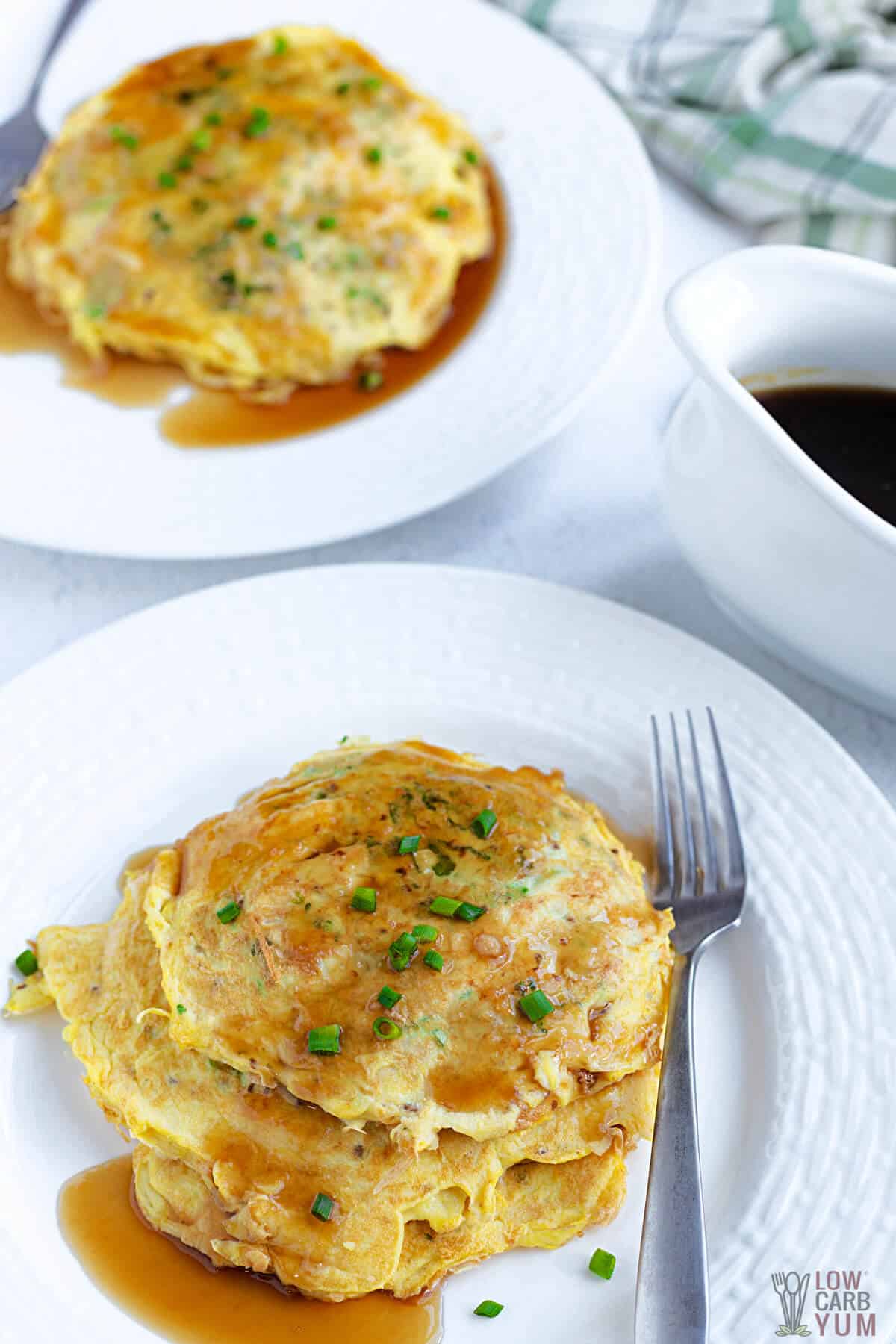 chinese omelettes served on white plates with sauce