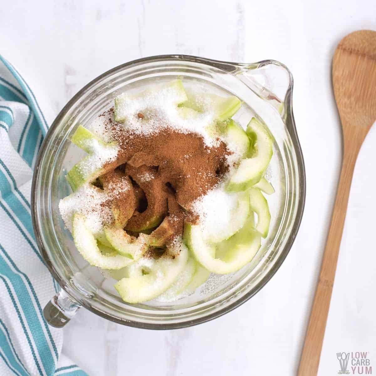 zucchini apple crips filling ingredients in glass mixing bowl.