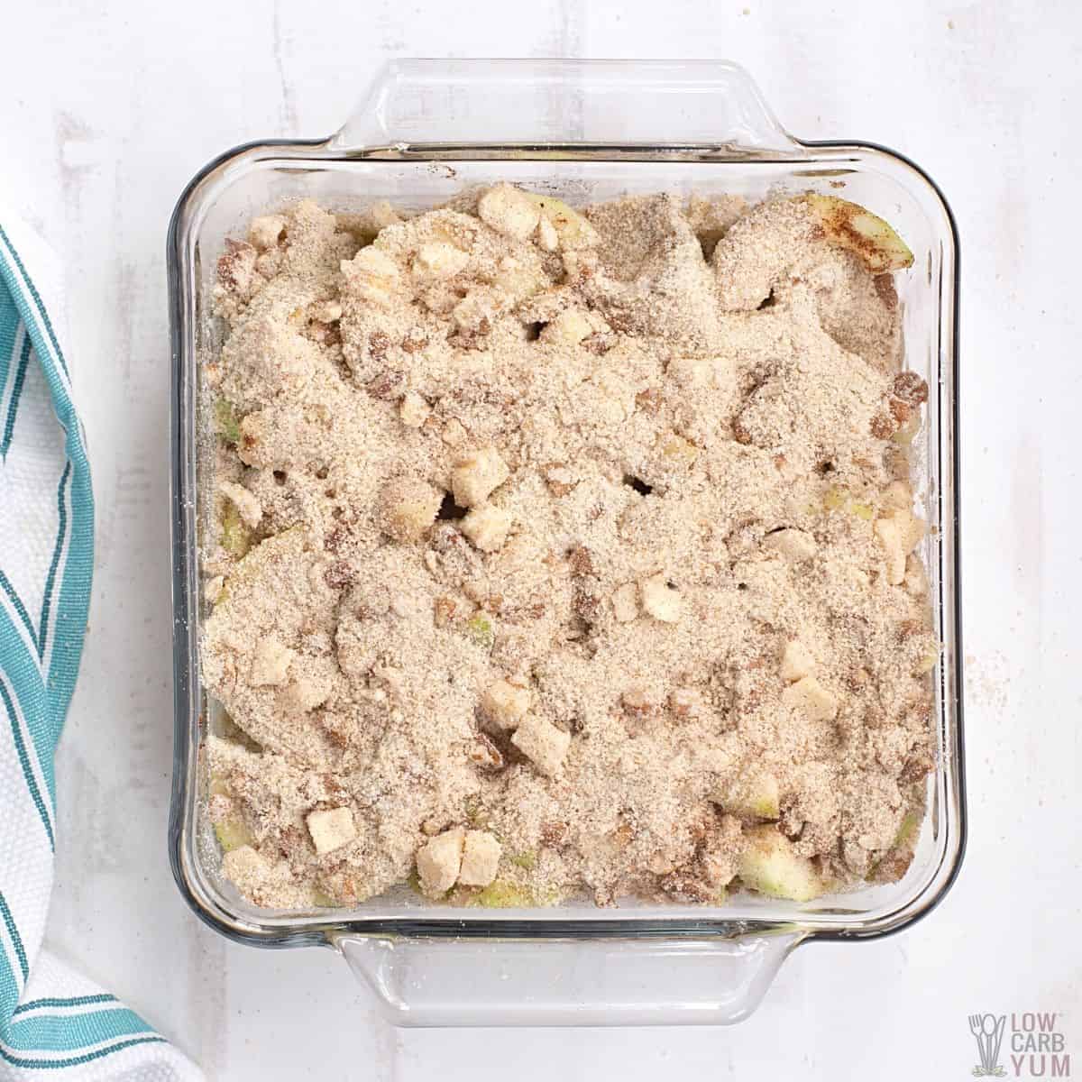 unbaked keto apple crisp in baking pan.