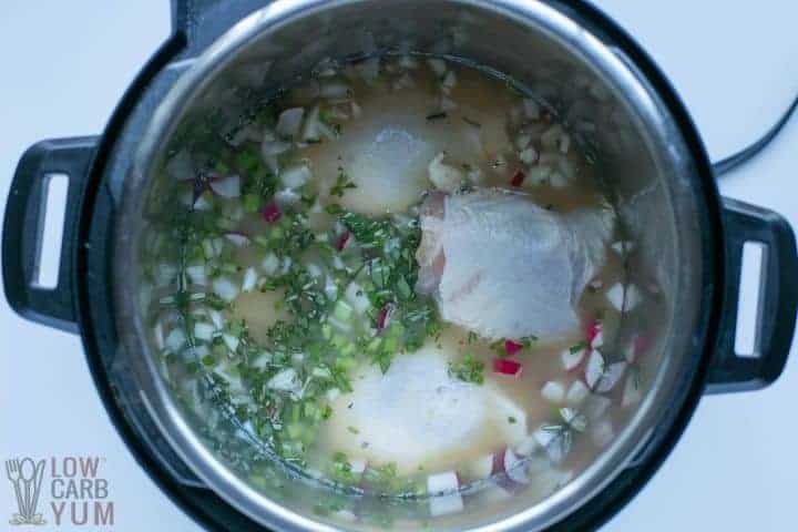 uncooked chicken soup in pot