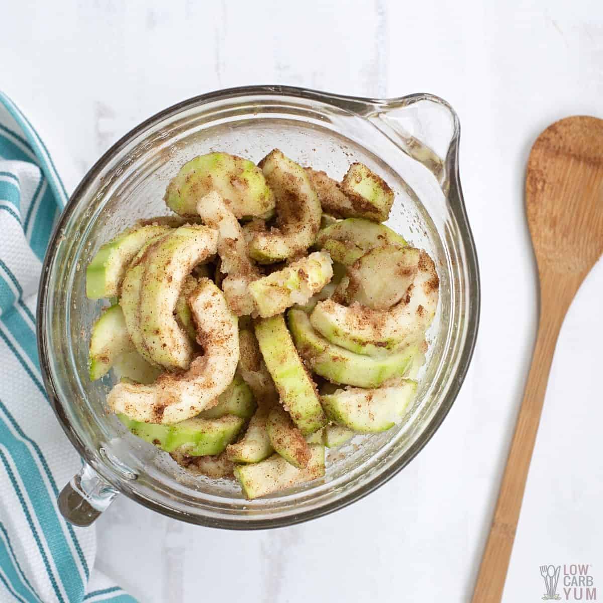 zucchini apple crisp filling mixture in glass mixing bowl.