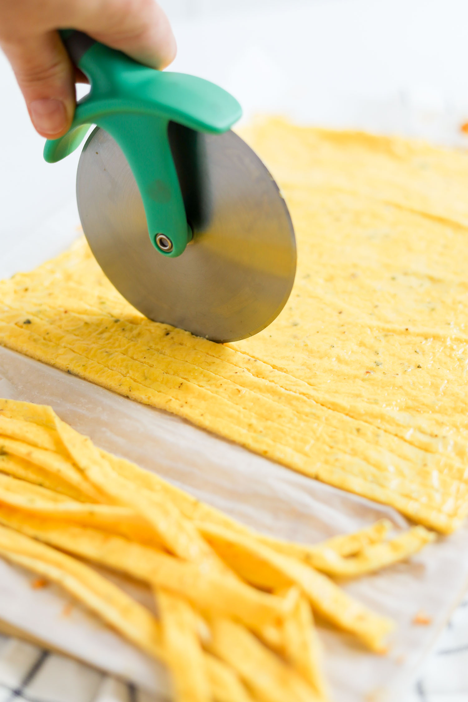 slicing low carb pasta with a pizza cutter 