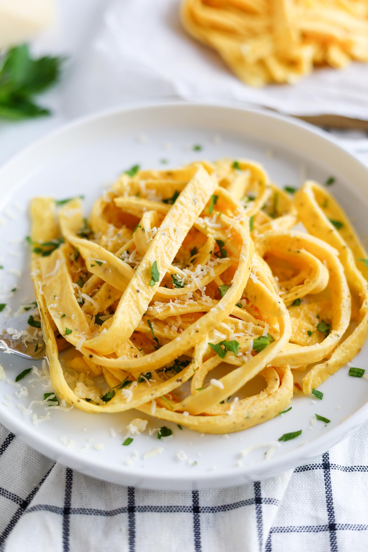 serving egg pasta in a bowl with herbs and cheese 