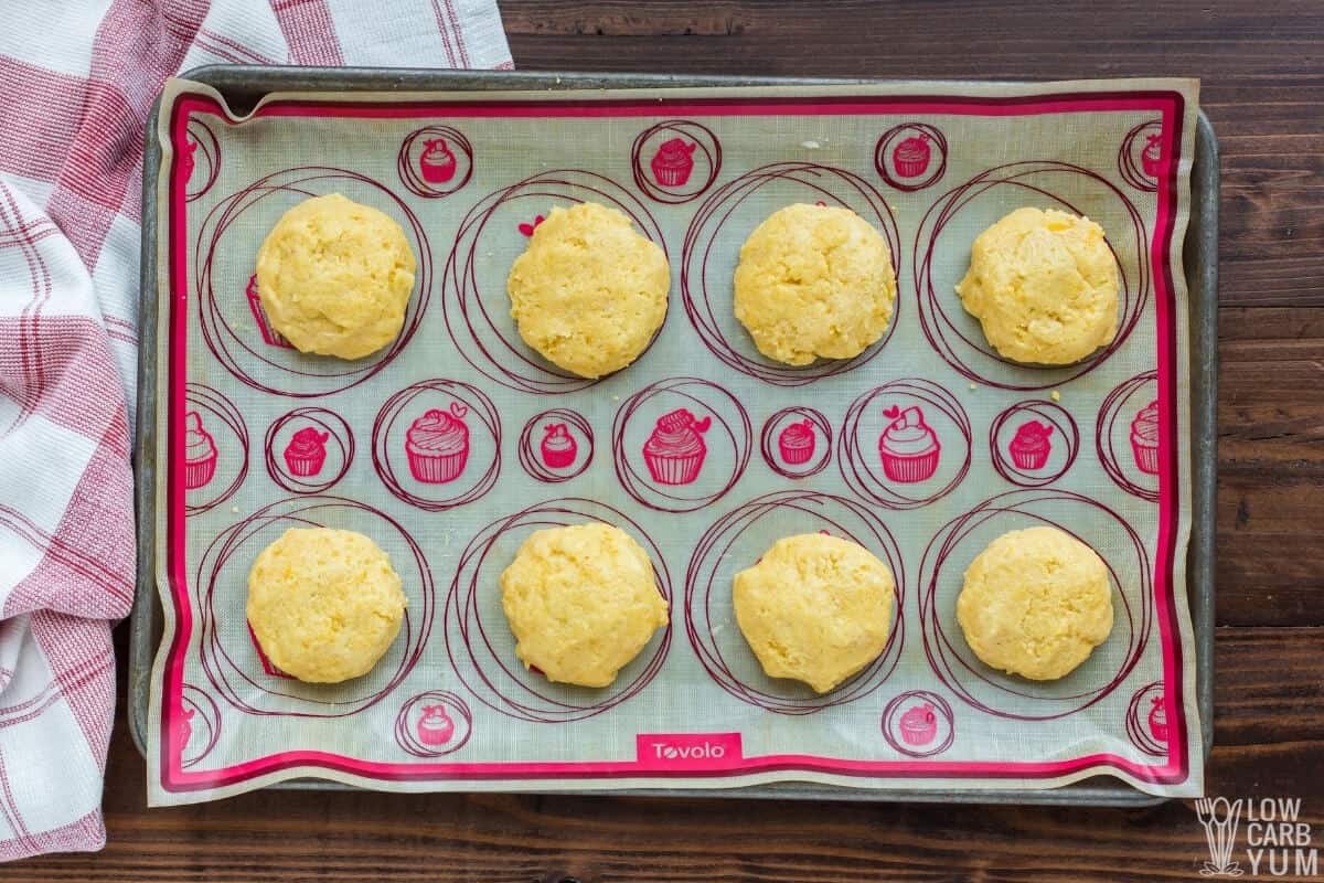 almond flour biscuit dough mounds on lined baking sheet