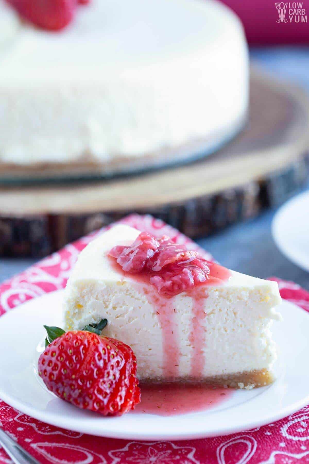 slice of keto cheesecake with strawberry sauce