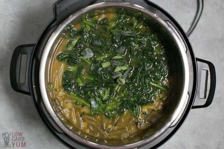 adding spinach to soup