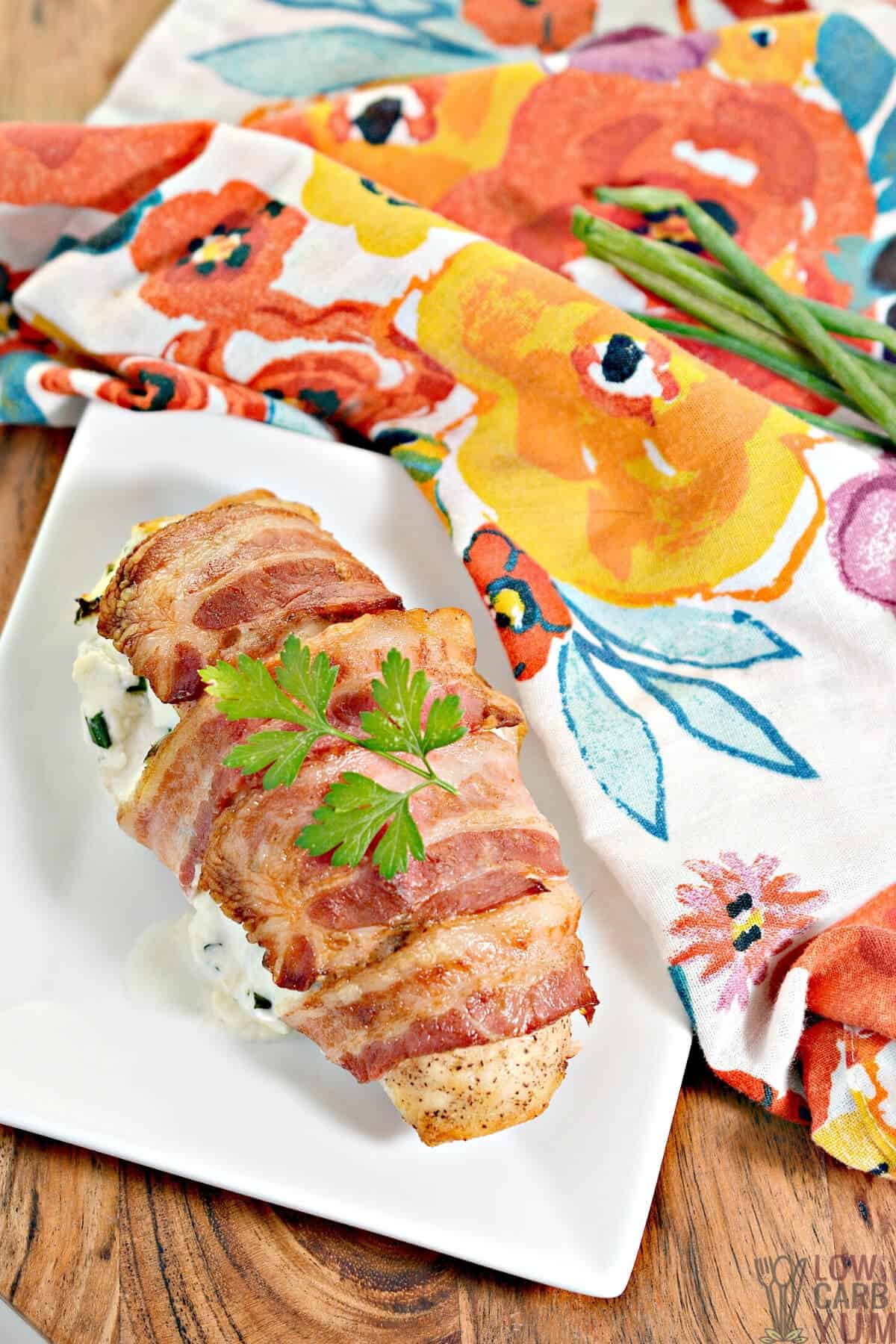 bacon wrapped cheesy stuffed chicken on plate