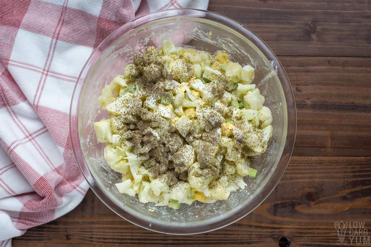 adding celery seeds to cauliflower salad