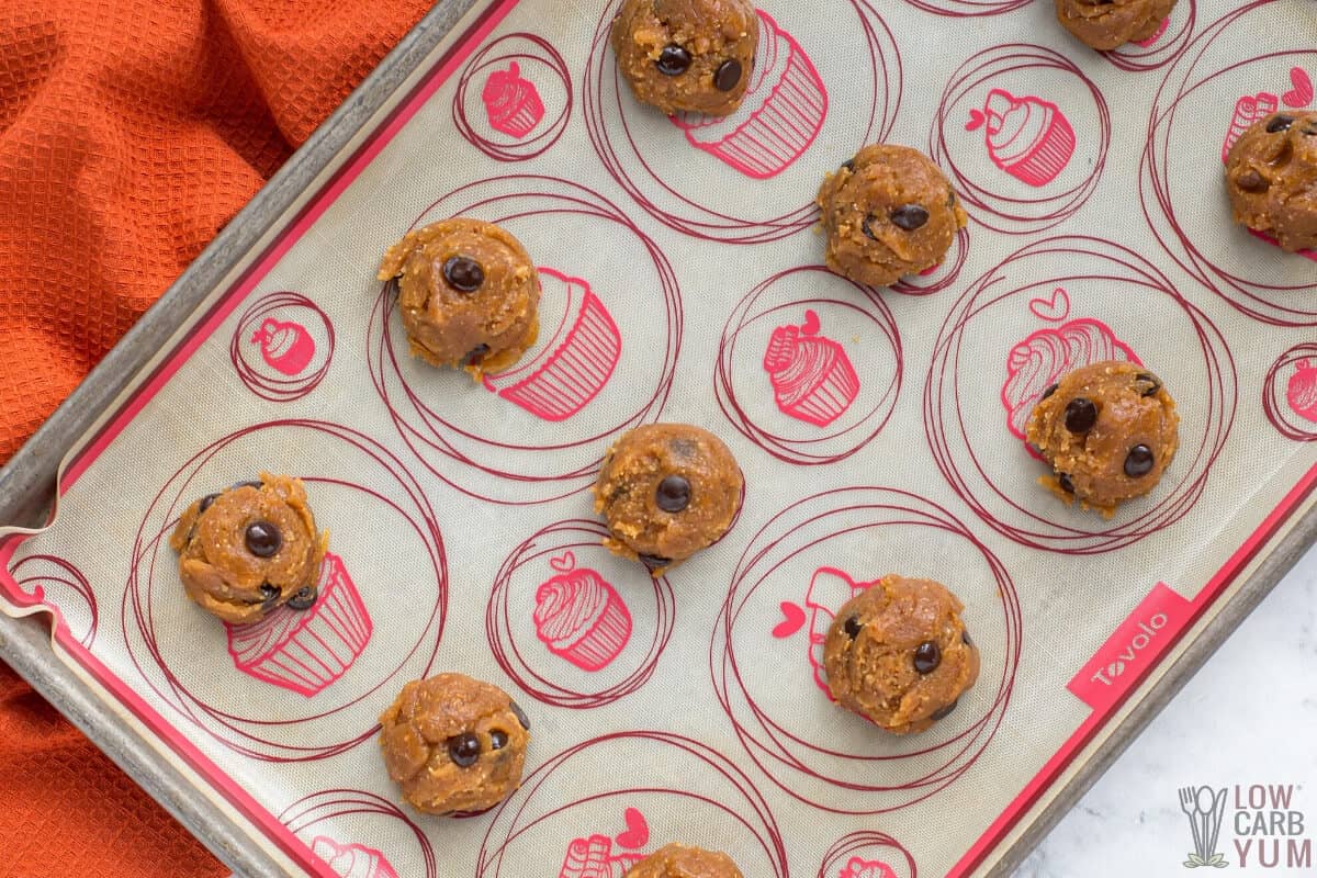 cookie dough balls on lined sheet